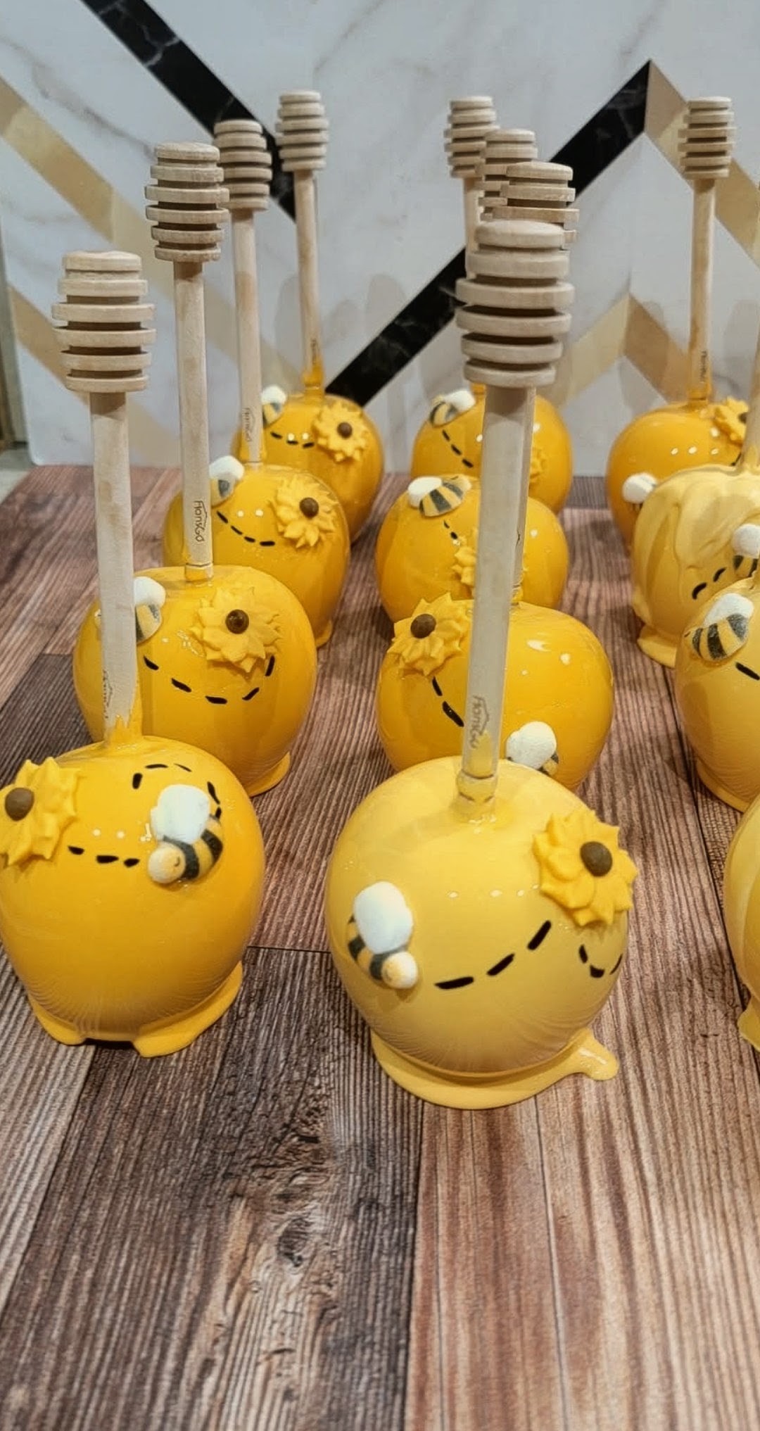 Bee themed yellow candy apples with honey dippers