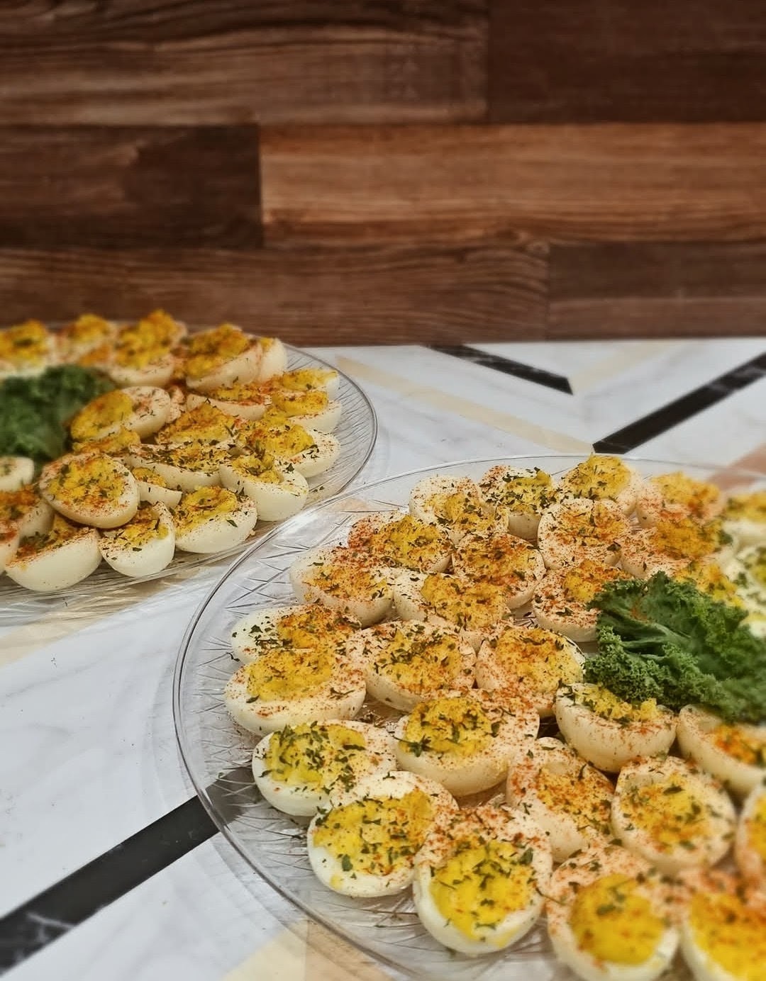Catering tray of deviled eggs sprinkled with paprika and herbs
