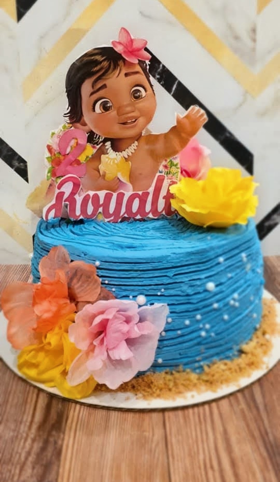 Ocean blue island themed second birthday cake with silk florals