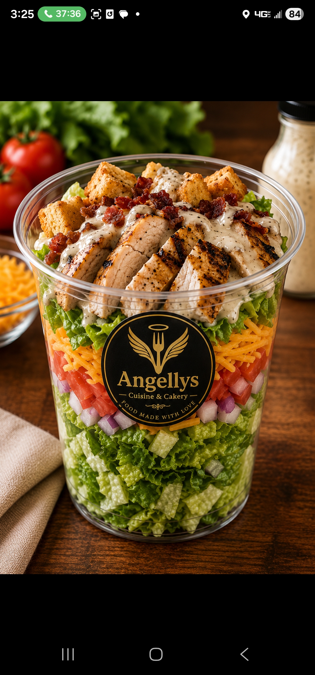 Layered Angell's salad cup with grilled chicken, bacon and ranch dressing