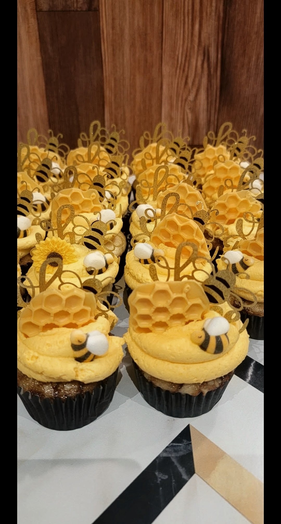 Bee themed cupcakes with honeycomb toppers and fondant bees