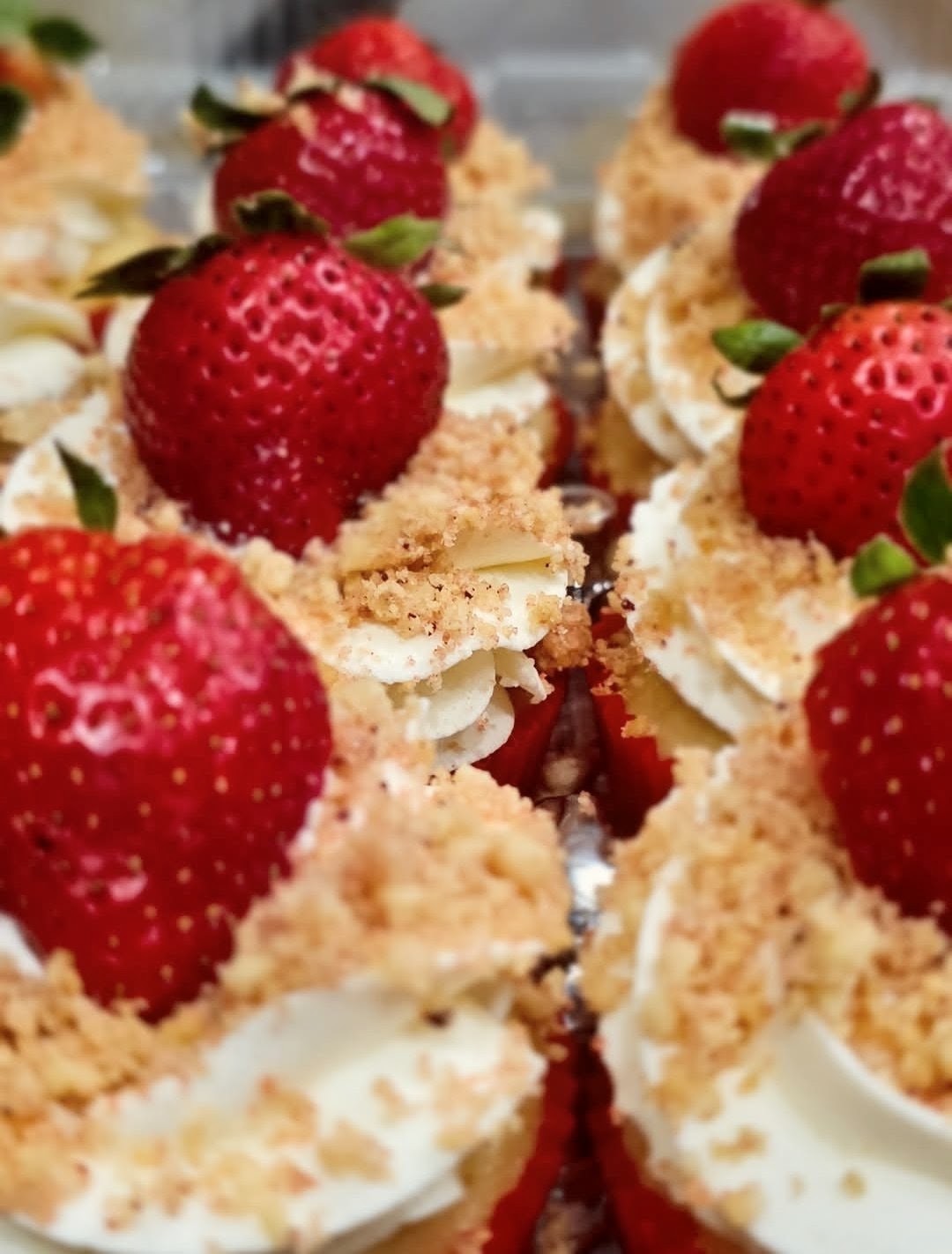 Strawberry shortcake cups topped with whipped cream and fresh strawberries
